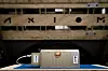 Axiom Space’s Data Center Unit-1 (AxDCU-1) on a bench with AXIOM in the background