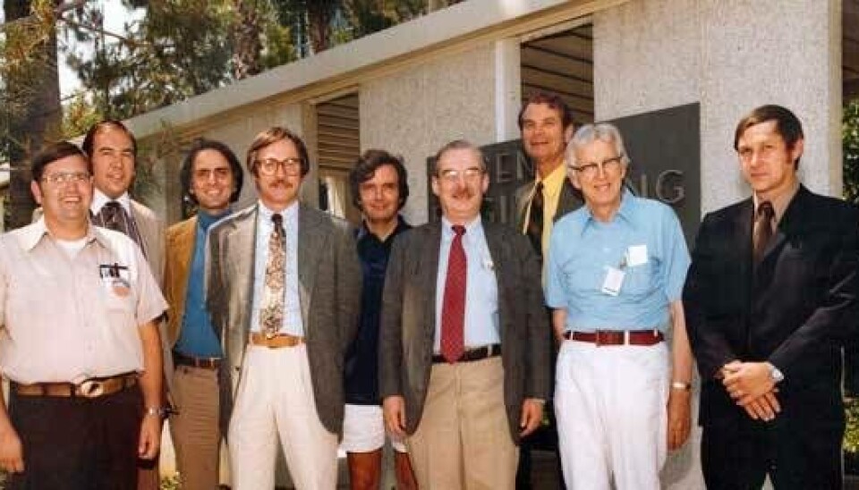 Nine Voyager Imaging Team members pose outside a building, with Carl Sagan among the group.