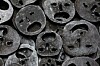 collection of metal masks cut with smiley faces