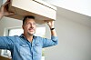 man carries heavy box to server room. Shutterstock 2534617759 carries heavy box to server room