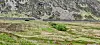 The breach in Eigiau from the far side of Cwm Eigiau. The dam is little more than a long concrete wall. The floodwater carved a channel into the valley floor before joining the Afon Porth-Llwyd in the foreground.