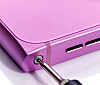 A Torx screwdriver being used to undo the single screw that holds on the Skyline's rear cover.
