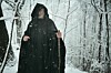 Old wizard in snowy forest