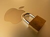 A padlock resting against the Apple logo