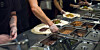 Chipotle workers assembling customers' burritos