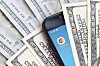 A phone showing the Chrome app icon buried in dollar bills