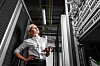 An IT worker staring up at a troublesome rack of equipment