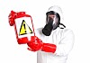 person in chemical repelling suit with a suspicious bottle