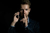 mystery man stands in shadows, talks on phone