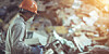 worker sorts through e-waste electronic waste