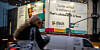 Someone walking by Slack's ad billboard in New York City
