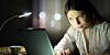 woman squints suspiciously at laptop