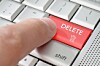 A finger pressing a delete key