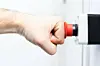 Picture of a person's fist hitting an emergency red button