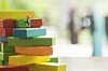 Little climbers move up a 'stack' of coloured blocks. Pic by SHutterstock