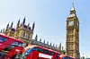 parliament buildings with buses going by