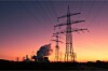 Power plant + electricity pylons at sunset