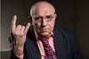 Elderly man making a horns gesture