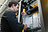 Someone removing or inserting equipment into a datacenter rack