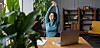 A happy looking worker at their desk stretching