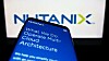 Someone holding up a phone against the Nutanix logo, the phone showing some marketing blurb for the vendor