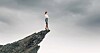 Illustration of someone standing on the edge of a precipice