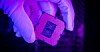 A gloved engineer's hand holding a modern Intel Core processor
