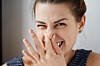 woman recoils because of bad smell