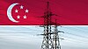 The flag of Singapore in front of a high voltage electricity transmission pylon