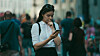 Someone looking skpetically at their smartphone