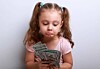 A child unhappy with her cash stash