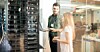 Two people standing next to racks of servers discussing work
