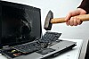man_destroying_laptop_with_hammer