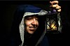 Kid with lantern and robe and a d20 gaming dice