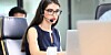 Someone working in an IT support desk role with telephone headset