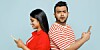 Indian man and woman using smartphones. The woman is happy, the man rather less so