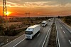 truck_fleet_on_highway_at_sunset