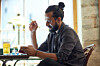 Man with bun sucks on vape. Photo by shutterstock