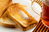 Tea mug wth buttered toast on a plate