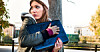 Someone clutching their laptop and looking over their shoulder