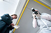 investigators with camera rubber gloves collect evidence
