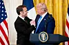 Macron shaking hands with Trump