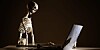 Skeleton working on computer