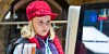 A child in a red hat using a computer