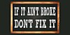 IF IT AIN'T BROKE DON'T FIX IT written on black wooden frame school blackboard