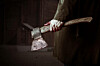man walks with bloody axe
