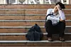 worker sits on steps after being told about redundancy