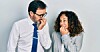 Two professionals looking nervous or stressed at each other in the office