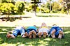Children playing outside, lie barefoot on grass. Photo by Shutterstock