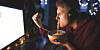 teen on PC eating ramen in the dark